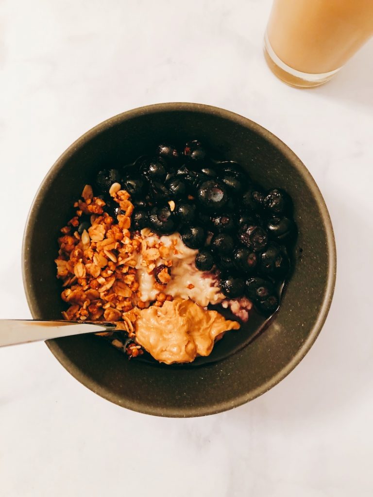 Light & Fluffy Easy Protein Oats! These banana & blueberry proats are perfect for a healthy breakfast or midday snack. Try out this healthy breakfast recipe paired with a cup of your favorite coffee, for a delish  & easy breakfast! | Vitality Vixens Healthy Lifestyle Blog